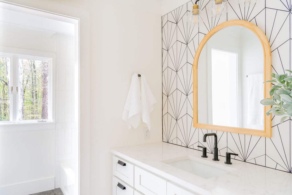 White bathroom vanity and patterned tile