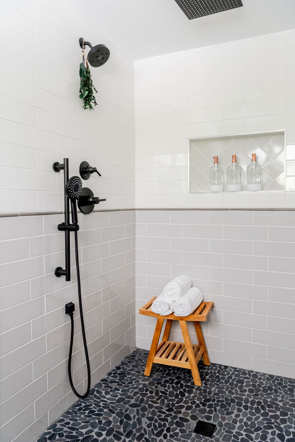 White shower with pebble floor